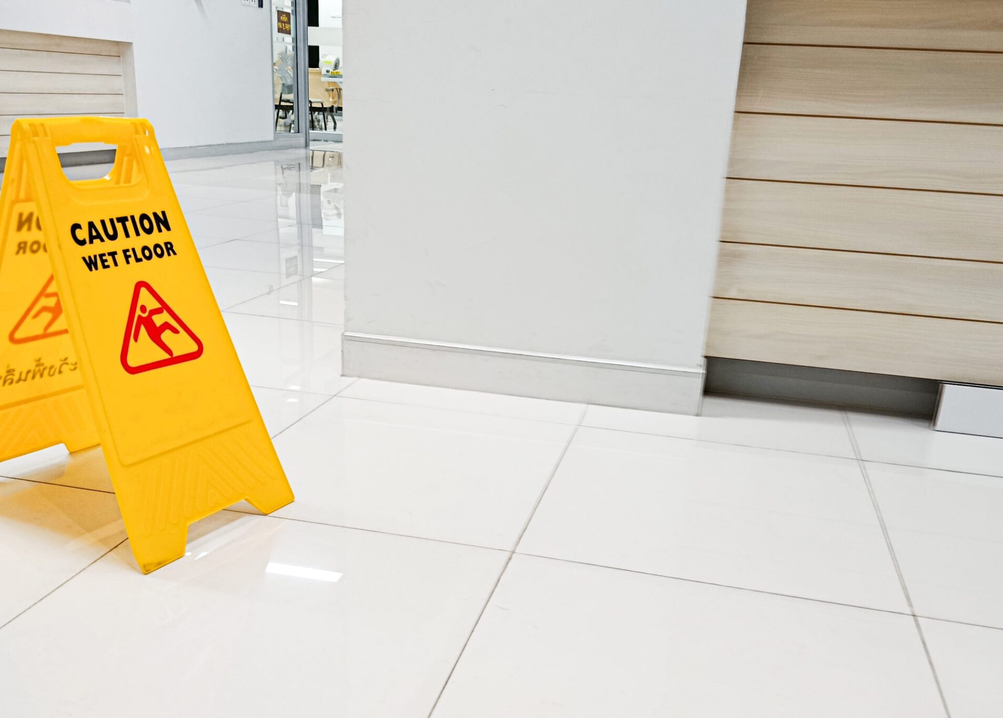 Signs indicate areas with wet floors or areas that are being cleaned. Be careful of slippery areas.