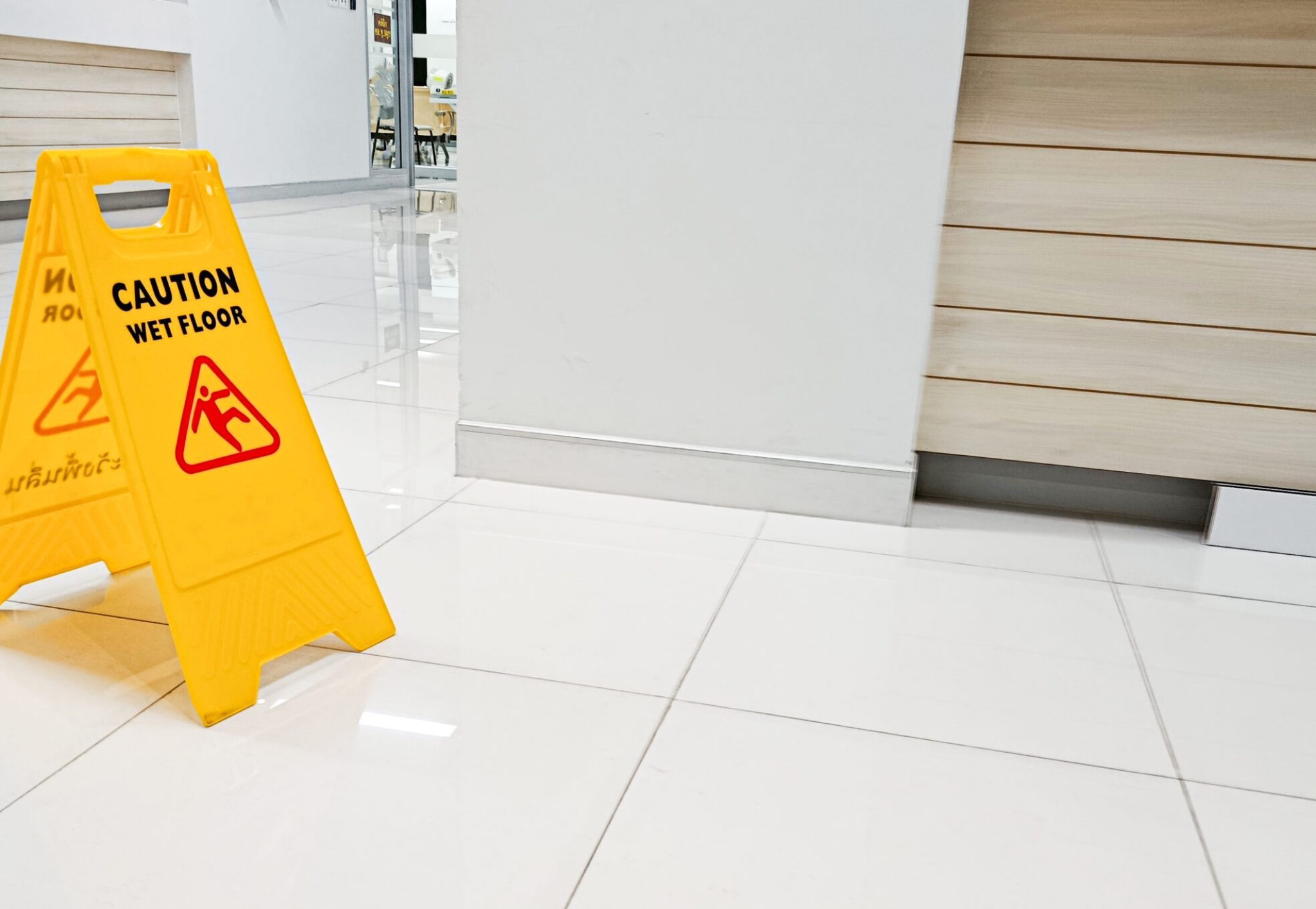 Signs indicate areas with wet floors or areas that are being cleaned. Be careful of slippery areas.